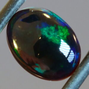 Blue and green flashing 1.46ct black Opal cabochon